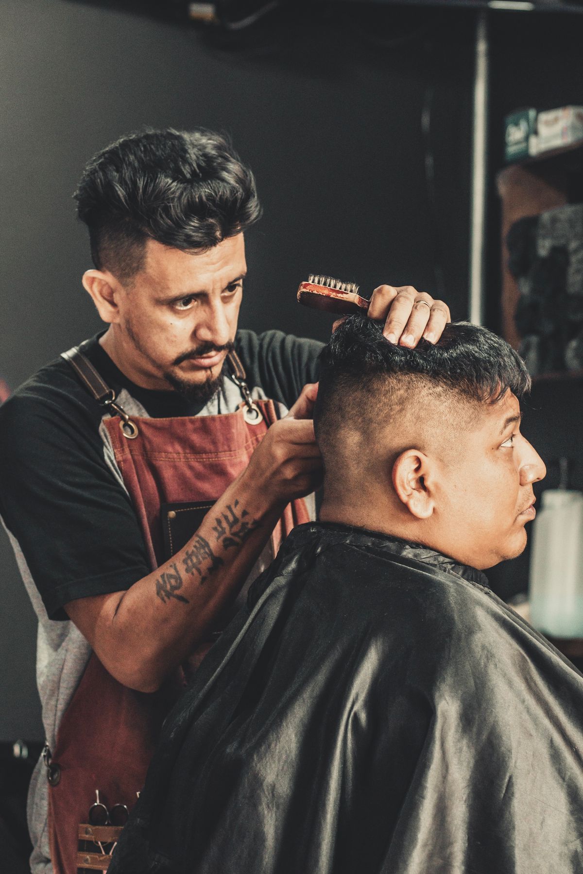 A barber at work (licensed stock placeholder — not this shop)