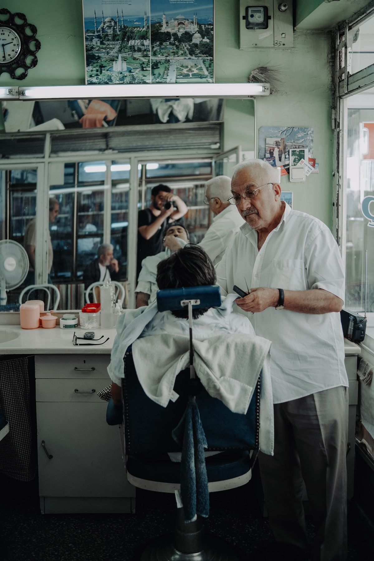 A barber at work (licensed stock placeholder — not this shop)